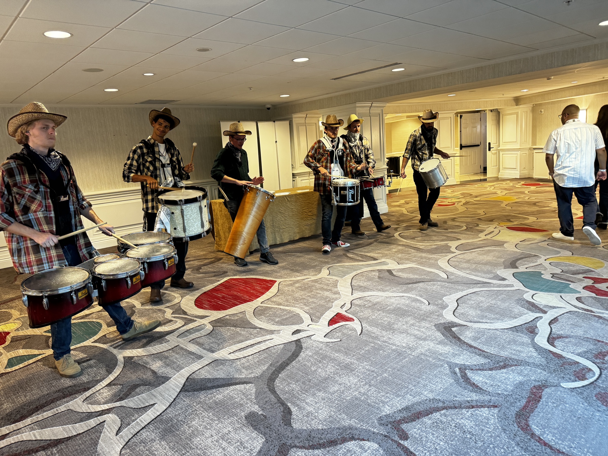 Six Nashville drumline performers moving through a corporate event venue